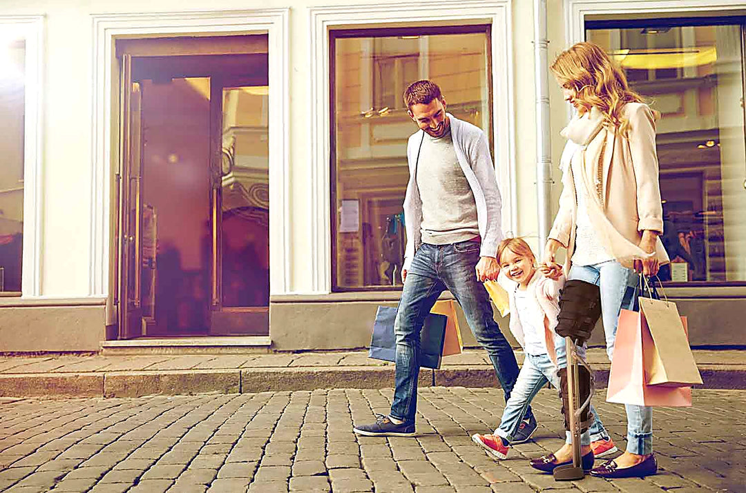 Family shopping together and the woman is using XLEG hands free crutch alternative — crutches alternative for active recovery, USA and Canada