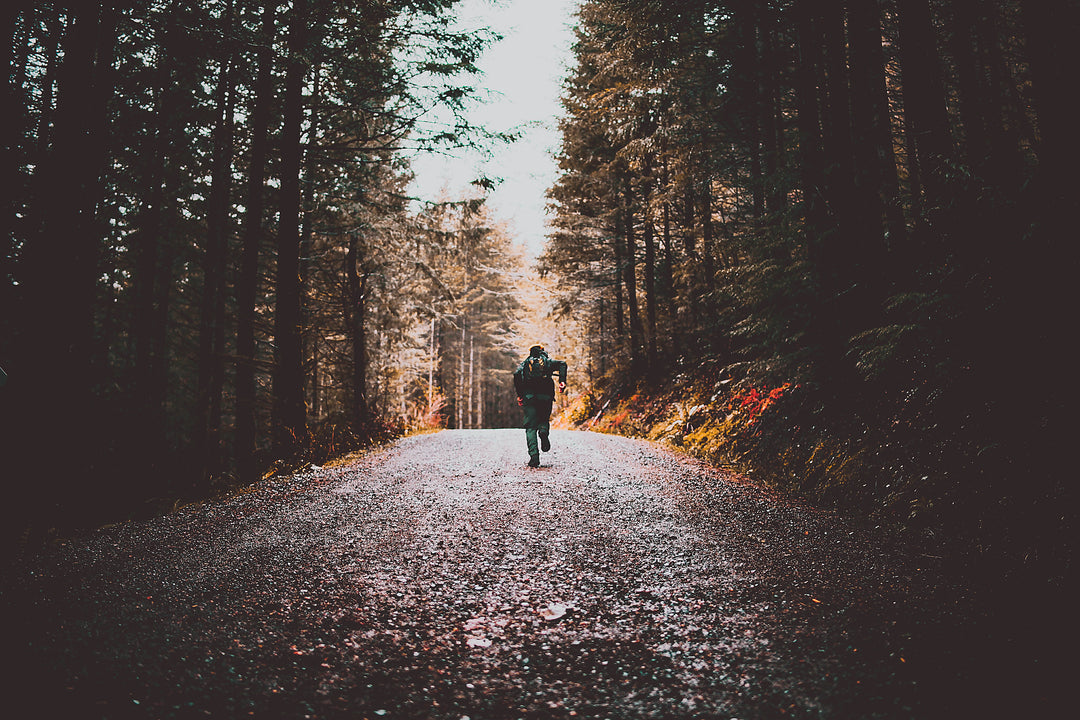 Person running on forest trail using XLEG hands free crutch alternative Canada — knee crutch for active outdoor recovery, Canada
