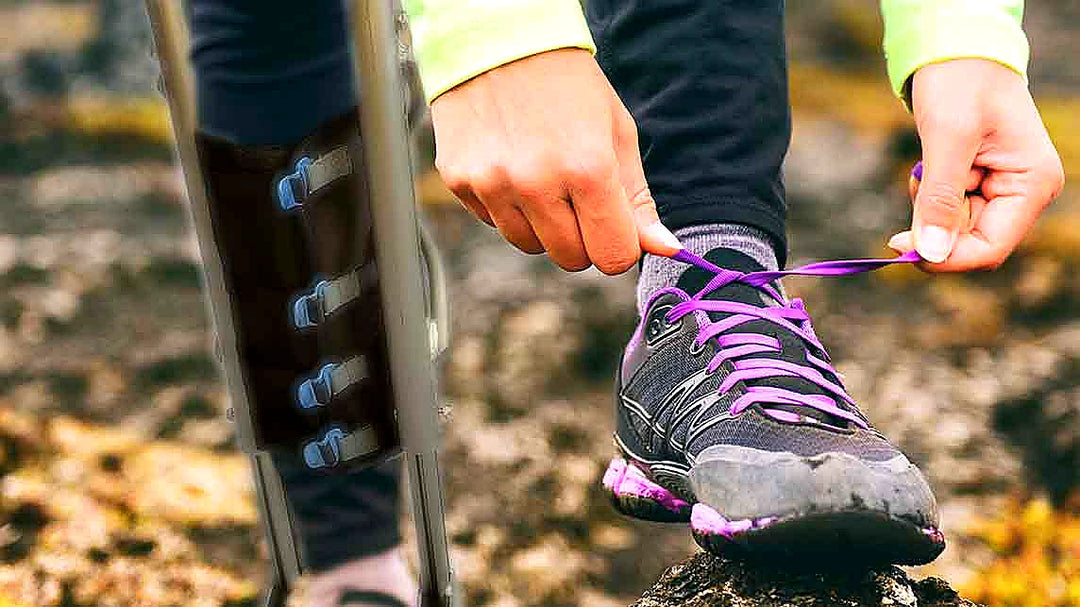 A close-up of a person tying shoe while wearing XLEG hands free crutch alternative — demonstrating its the best hands free crutches during lower leg recovery for active people